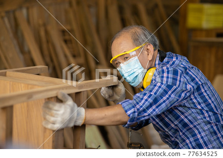 Elder worker wood woodcraft retire hobby for good retirement, Asian male mature professional master of making wooden furniture with face mask protective. Elder worker wood woodcraft retire hobby for good retirement, Asian male mature professional master of making wooden furniture with face mask protective. 77634525