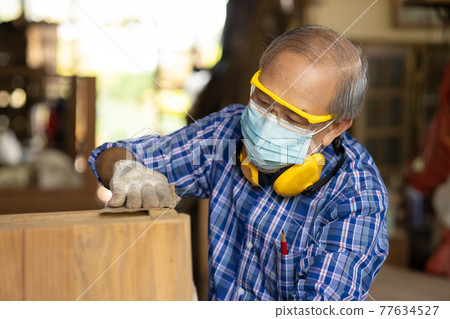 Elder worker wood woodcraft retire hobby for good retirement, Asian male mature professional master of making wooden furniture with face mask protective. Elder worker wood woodcraft retire hobby for good retirement, Asian male mature professional master of making wooden furniture with face mask protective. 77634527