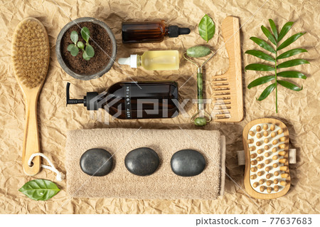 Natural cosmetic SPA products on crumpled kraft paper background, top view. Organic beauty product packaging design Natural cosmetic SPA products on crumpled kraft paper background, top view. Organic beauty product packaging design 77637683