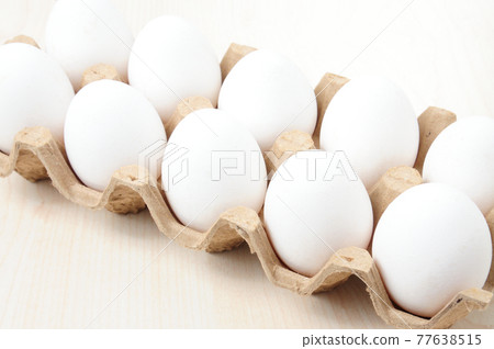 White chicken eggs in a checkered package 77638515