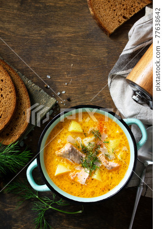 Norwegian cuisine. Soup with cream and salmon on a rustic wooden table. Top view flat lay background. Copy space. Norwegian cuisine. Soup with cream and salmon on a rustic wooden table. Top view flat lay background. Copy space. 77638642