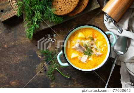 Norwegian cuisine. Soup with cream and salmon on a rustic wooden table. Top view flat lay background. Copy space. Norwegian cuisine. Soup with cream and salmon on a rustic wooden table. Top view flat lay background. Copy space. 77638643