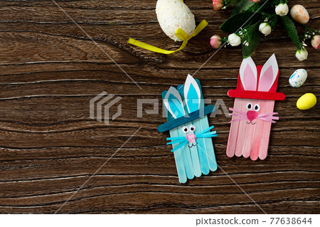 Easter bunny toy gift stics puppets on wooden table. Copy space. Handmade. Project of children's creativity, crafts for kids. Easter bunny toy gift stics puppets on wooden table. Copy space. Handmade. Project of children's creativity, crafts for kids. 77638644
