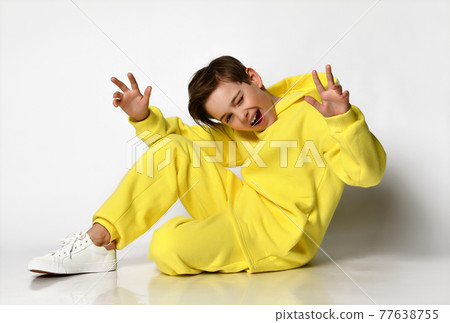 Stylish active guy in a bright yellow sports suit Stylish active guy in a bright yellow sports suit 77638755