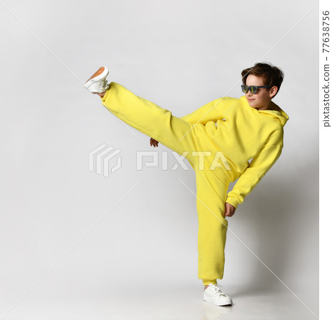 Boy dressed in a bright yellow sports suit and Boy dressed in a bright yellow sports suit and 77638756