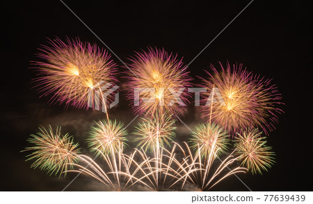 International fireworks festival display at night. Variety of colorful fireworks in holidays celebration isolated on black. Happy New Year Background. 77639439