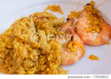 Close up of rice with onion and shrimps: selective focus: Homemade and traditional food concept. Close up of rice with onion and shrimps: selective focus: Homemade and traditional food concept. 77639923