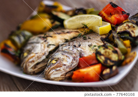 Sea bass with grilled vegetables. High quality photo. 77640108