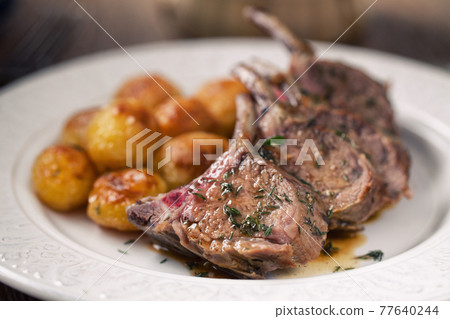 Grilled lamb chops with potatoes. High quality photo. Grilled lamb chops with potatoes. High quality photo. 77640244