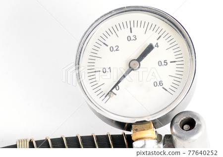 Pressure gauge for measuring air pressure in car tires on a white background 77640252