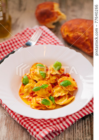 Ravioli with tomato sauce. Typical italian dish. 77640266