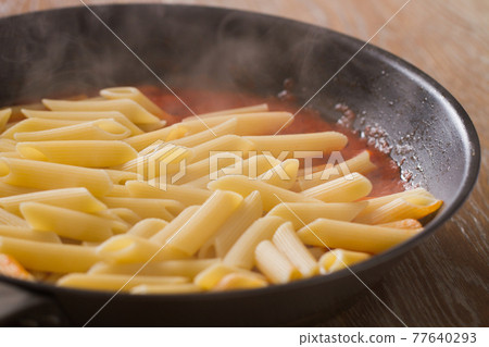 Pasta with tomato sauce on a pan. High quality photo 77640293