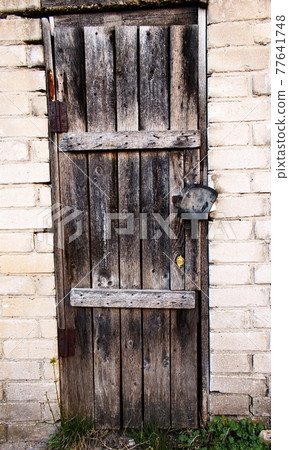 Old Halloween spooky wooden door with a hidden lock 77641748