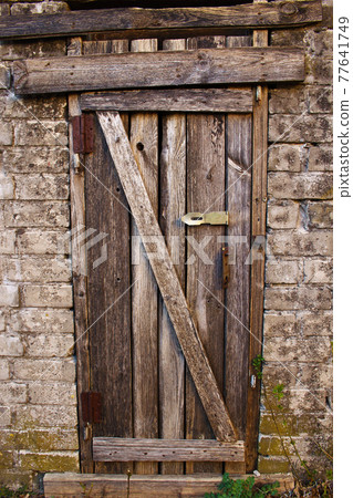 Unlocked aged Halloween creepy old wooden door 77641749