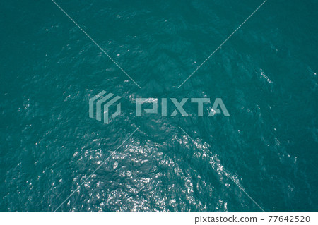 Background image of the tropical sea surface water smooth surface ocean reflection of sun Top view by Drone camera Background image of the tropical sea surface water smooth surface ocean reflection of sun Top view by Drone camera 77642520