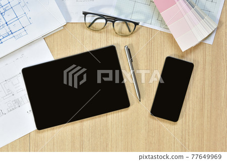 a top view of architect working desk with equipment for drawings pens sketched idea on wood table, the concept of modern technology for architectural working with tablet a top view of architect working desk with equipment for drawings pens sketched idea on wood table, the concept of modern technology for architectural working with tablet 77649969
