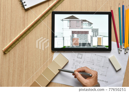 a tablet showing architectural drawing design detail selection of building color with digital pens on wood table, the concept of new technology for working of tablet with digital pen a tablet showing architectural drawing design detail selection of building color with digital pens on wood table, the concept of new technology for working of tablet with digital pen 77650251