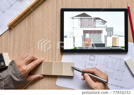 a tablet showing architectural drawing design detail selection of building color with digital pens on wood table, the concept of new technology for working of tablet with digital pen a tablet showing architectural drawing design detail selection of building color with digital pens on wood table, the concept of new technology for working of tablet with digital pen 77650252