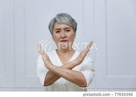 一位銀髮白髮的年長婦女在落地窗旁 一位銀髮白髮的年長婦女在落地窗旁 77650398