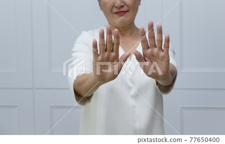 一位銀髮白髮的年長婦女在落地窗旁 一位銀髮白髮的年長婦女在落地窗旁 77650400