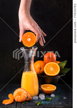 glass of fresh orange juice with fresh fruits on wooden glass of fresh orange juice with fresh fruits on wooden 77650763