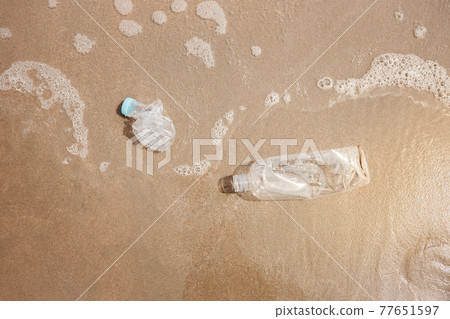 Environment, Ecology Care, Renewable Concept. Plastic Bottle Waste on the Beach Sand. Top View Environment, Ecology Care, Renewable Concept. Plastic Bottle Waste on the Beach Sand. Top View 77651597