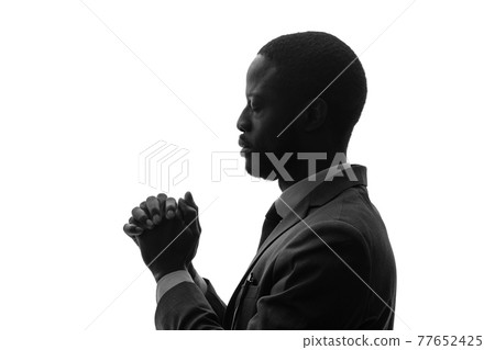 Black man silhouette praying Black man silhouette praying 77652425