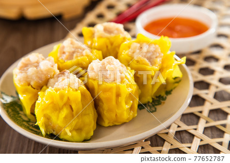 Siu Mai - Chinese steamed pork dumplings in bamboo steamers. Dim Sum Siu Mai - Chinese steamed pork dumplings in bamboo steamers. Dim Sum 77652787