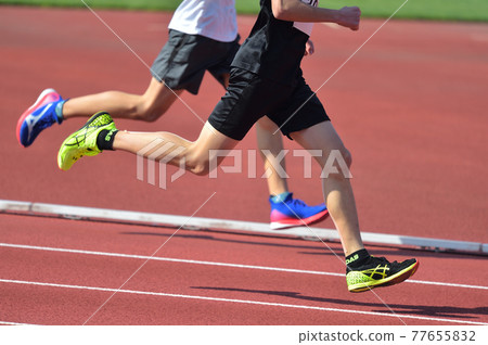 Track and field running on a track 77655832