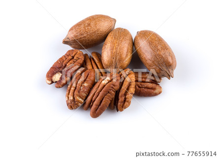 Few pecan nuts isolated on white Few pecan nuts isolated on white 77655914