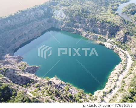 Black or Radon Lake in the Nikolaev region of Ukraine from a bird's eye view. Flooded granite quarry, aerial view, landscape. 77656195