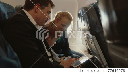 Family of three in plane with smartphone and tablet PC Family of three in plane with smartphone and tablet PC 77656678