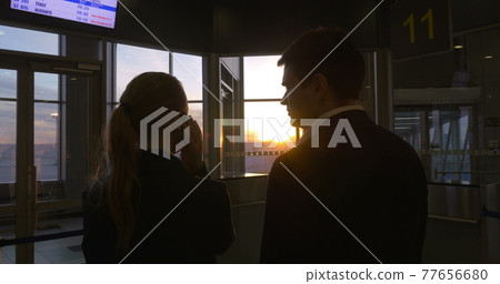 Young people at the airport at sunset 77656680