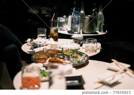 A table with alcohol and food A table with alcohol and food 77658923