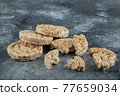 Broken crispbread slices on big marble background 77659034