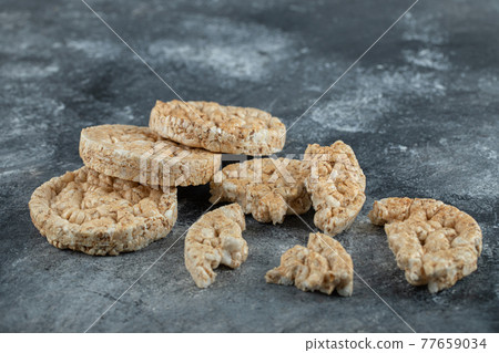 Broken crispbread slices on big marble background Broken crispbread slices on big marble background 77659034