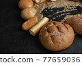 Different types of pastries on a parchment paper 77659036