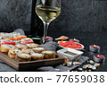 Mix sushi set with a glass of white wine 77659038