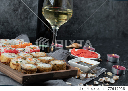 Mix sushi set with a glass of white wine 77659038