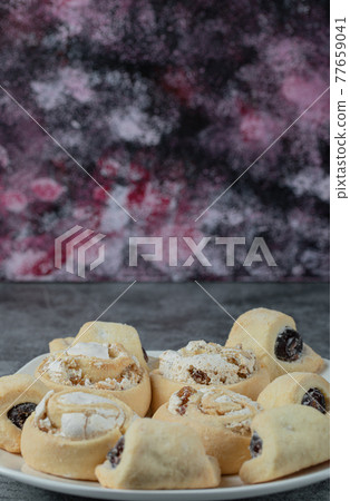 Butter cookies with sugar powder in a white ceramic plate Butter cookies with sugar powder in a white ceramic plate 77659041