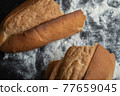 Top view of freshly baked bread on blackboard 77659045