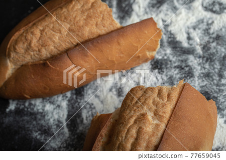 Top view of freshly baked bread on blackboard 77659045