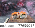 Sushi maki with red caviar and cream cheese on a wooden board 77659047