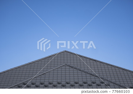 Brown corrugated metal profile roof installed on a modern house. The roof of corrugated sheet. Roofing of metal profile wavy shape. Modern roof made of metal. Metal roofing. Brown corrugated metal profile roof installed on a modern house. The roof of corrugated sheet. Roofing of metal profile wavy shape. Modern roof made of metal. Metal roofing. 77660103