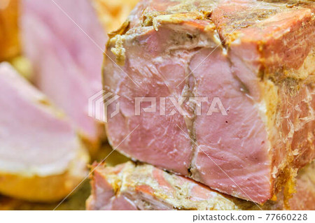 Slices of ham on a store counter. 77660228