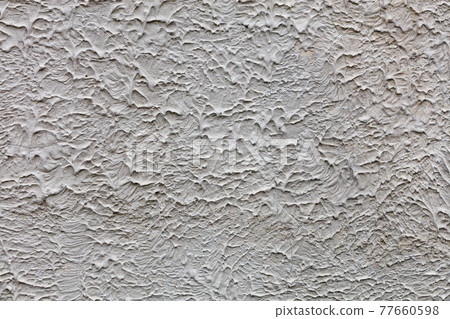 A gray textured wall covered with a frozen liquid concrete mixture, background and texture, close-up. A gray textured wall covered with a frozen liquid concrete mixture, background and texture, close-up. 77660598