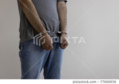 A man wearing handcuffs (30s, Japanese). Image of arrest 77660656