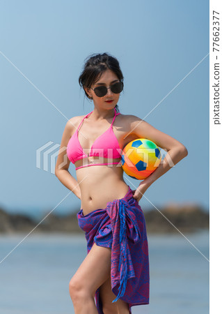 Portrait of thai woman posing outdoors at the sea beach 77662377