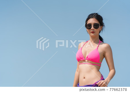 Portrait of thai woman posing outdoors at the sea beach 77662378