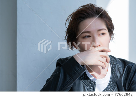 Genderless LGBT woman wearing a leather jacket Genderless LGBT woman wearing a leather jacket 77662942